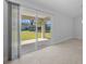 Bright living room featuring tile floors, sliding glass doors to outdoor patio, and neutral paint at 3010 Sw 137Th Pl, Ocala, FL 34473