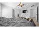 Well-lit main bedroom with a ceiling fan and large tv at 3010 Sw 137Th Pl, Ocala, FL 34473