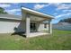 Rear patio area featuring a covered area and access into the home at 3010 Sw 137Th Pl, Ocala, FL 34473