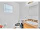 Bathroom features a vanity with a granite-look countertop, a toilet, and a wall mirror at 307 Nw 10Th Ave, Ocala, FL 34475