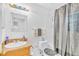 Well-lit bathroom featuring a vanity with sink, toilet, and shower with neutral colored curtain at 307 Nw 10Th Ave, Ocala, FL 34475