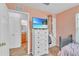 Small bedroom featuring a dresser with a wall-mounted television, and a view of the en-suite bathroom at 307 Nw 10Th Ave, Ocala, FL 34475