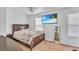 Comfortable bedroom with natural light, a wood bed frame, wall-mounted television and closet at 307 Nw 10Th Ave, Ocala, FL 34475