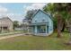 Charming two-story blue home featuring a covered front porch with seating, and a well manicured lawn at 307 Nw 10Th Ave, Ocala, FL 34475