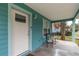 Inviting front porch with seating, featuring a white door and light blue siding at 307 Nw 10Th Ave, Ocala, FL 34475