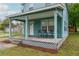 Traditional home with a covered front porch and seating, complemented by a manicured lawn at 307 Nw 10Th Ave, Ocala, FL 34475