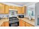 Kitchen featuring wood cabinets, stainless steel appliances, and modern fixtures at 307 Nw 10Th Ave, Ocala, FL 34475
