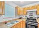 Functional kitchen featuring wood cabinetry, stainless steel appliances, and a double sink at 307 Nw 10Th Ave, Ocala, FL 34475