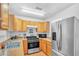 Bright kitchen with stainless steel appliances, wood cabinets, and updated fixtures at 307 Nw 10Th Ave, Ocala, FL 34475