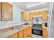 Well-equipped kitchen featuring wood cabinets, stainless steel appliances, and a window at 307 Nw 10Th Ave, Ocala, FL 34475