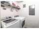 Laundry room with white washer and dryer, shelving for storage, and quirky decorations at 307 Nw 10Th Ave, Ocala, FL 34475