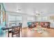 Open-concept living and dining area featuring a leather sectional and ample natural light at 307 Nw 10Th Ave, Ocala, FL 34475