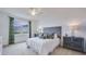 Calm bedroom with a comfortable bed, ceiling fan, carpet, and a large window at 3990 Nw 48Th Terrace Rd, Ocala, FL 34482