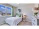 Cozy bedroom with carpet, a big window, and simple furnishings at 3990 Nw 48Th Terrace Rd, Ocala, FL 34482