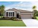 Charming single-story home boasts a manicured lawn, stone accents, and a convenient two-car garage at 3990 Nw 48Th Terrace Rd, Ocala, FL 34482