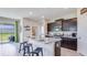 Modern kitchen featuring a large island, granite countertops, stainless steel appliances, and ample storage at 3990 Nw 48Th Terrace Rd, Ocala, FL 34482