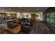Comfortable lounge with leather seating, large screens, and tables for dining or games at 3990 Nw 48Th Terrace Rd, Ocala, FL 34482