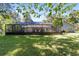 Wide backyard with an in-ground pool featuring a screened enclosure and well-kept lawn at 4245 Se 24Th Ter, Ocala, FL 34480