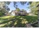 Spacious backyard with a screened-in patio and a lush lawn perfect for outdoor activities at 4245 Se 24Th Ter, Ocala, FL 34480