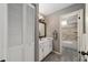 Bathroom with a single sink vanity, wooden framed mirror, and a view into the shower/tub area at 4245 Se 24Th Ter, Ocala, FL 34480