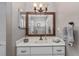 Bathroom featuring a single sink vanity with white cabinets and a framed mirror at 4245 Se 24Th Ter, Ocala, FL 34480