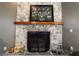 Close-up of the stone fireplace with a wooden mantel and decorative Gathering photo above at 4245 Se 24Th Ter, Ocala, FL 34480