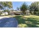 Landscaped single-story home with a well-manicured lawn and shade trees at 4245 Se 24Th Ter, Ocala, FL 34480