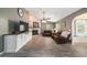 Spacious living room featuring stone fireplace, comfortable leather sofas, and wood-look tile flooring at 4245 Se 24Th Ter, Ocala, FL 34480