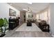 Bright and spacious living room with wood-look tile flooring, a ceiling fan, and comfortable seating at 4245 Se 24Th Ter, Ocala, FL 34480