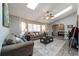 Open-concept living room featuring wood-look tile flooring, skylights and comfortable seating at 4245 Se 24Th Ter, Ocala, FL 34480