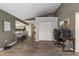 Open living space featuring bar seating, office area, closet, and wood-look tile flooring at 4245 Se 24Th Ter, Ocala, FL 34480