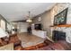 Expansive living area showcasing a stone fireplace, tv, office space, and open layout at 4245 Se 24Th Ter, Ocala, FL 34480