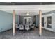 Covered patio features brick flooring, ceiling fan, and dining table for outdoor entertaining at 4245 Se 24Th Ter, Ocala, FL 34480