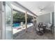 Covered patio area with outdoor seating and a view of the screened-in pool at 4245 Se 24Th Ter, Ocala, FL 34480