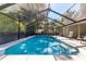 Beautiful in-ground pool in screened enclosure featuring sun-shelf entry at 4245 Se 24Th Ter, Ocala, FL 34480
