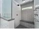 Luxurious shower featuring subway tile walls, patterned accent tile and a built-in bench at 4245 Se 24Th Ter, Ocala, FL 34480
