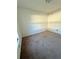 Empty bedroom featuring a carpeted floor, base molding, and natural light from a window at 43 Pine Radl, Ocala, FL 34472
