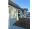 Single-story home featuring an entry porch, mulched garden bed, and grey paint scheme at 43 Pine Radl, Ocala, FL 34472