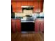 Stainless steel oven with tile backsplash and cherry wood cabinets at 43 Pine Radl, Ocala, FL 34472