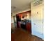 Cherry wood kitchen cabinets with modern appliances and black countertops at 43 Pine Radl, Ocala, FL 34472