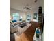 Bright living room with a ceiling fan, a large window, and modern furniture at 43 Pine Radl, Ocala, FL 34472
