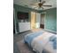 Cozy bedroom featuring a ceiling fan, a dresser, and closet access at 43 Pine Radl, Ocala, FL 34472