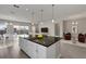 Spacious kitchen with a large island, black countertops, white cabinets, and seamless access to the living and dining areas at 4546 Nw 53Rd Avenue Rd, Ocala, FL 34482