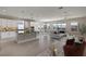 Open-concept living room featuring hardwood floors, modern lighting, and a seamless flow into the kitchen and dining area at 4546 Nw 53Rd Avenue Rd, Ocala, FL 34482