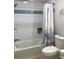 Clean bathroom featuring a tiled bathtub with shower, updated fixtures, and ample lighting at 509 Del Mar Dr, Lady Lake, FL 32159