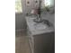 Bathroom vanity with double sinks, marble countertop, and decorative flowers at 509 Del Mar Dr, Lady Lake, FL 32159