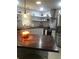 Bright kitchen with butcher block countertops, stainless steel appliances, and decorative open shelving at 509 Del Mar Dr, Lady Lake, FL 32159