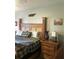 Comfortable main bedroom with a decorative headboard, nightstand, and colorful decor at 509 Del Mar Dr, Lady Lake, FL 32159