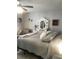 Cozy main bedroom features a plush bed, accent chair, and decorative floral mirror at 509 Del Mar Dr, Lady Lake, FL 32159