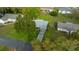 Aerial view of a well-maintained home with a lush backyard and a long driveway in a serene neighborhood at 6385 Sw 61St Ct, Ocala, FL 34474